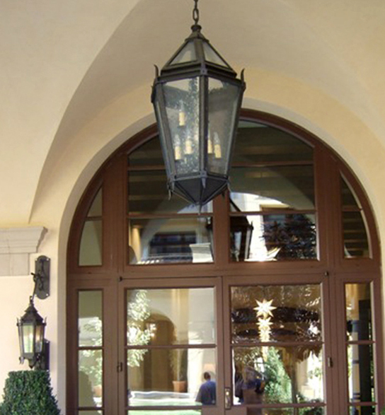 Single lantern hung over a large, arched window